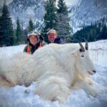 Two Elk Ridge guests pose behind a large mountain goat they've taken down