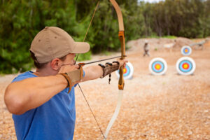 man practicing archery