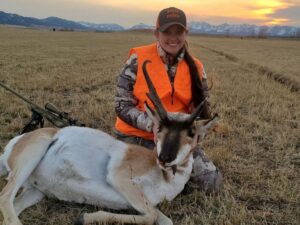 woman posing with antelope she just took down with rifle