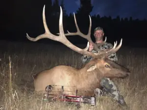 An Elk Ridge Outfitters guests holds up the antlers of the Elk he's successfully hunted