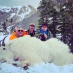 Three Elk Ridge Outfitters hunters pose with a Mountain Goat